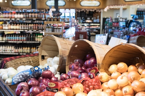 Interior image of onions in the produce department in a market.
