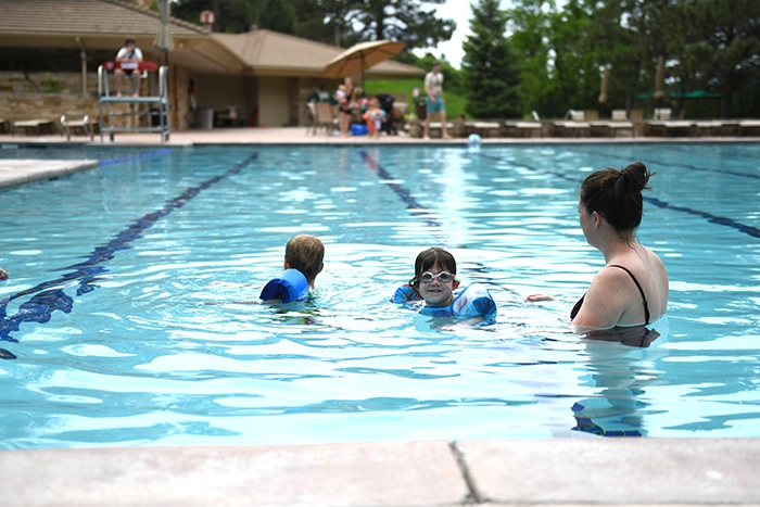Kids and a mom playing in one of the pools at the Village at Castle Pines.