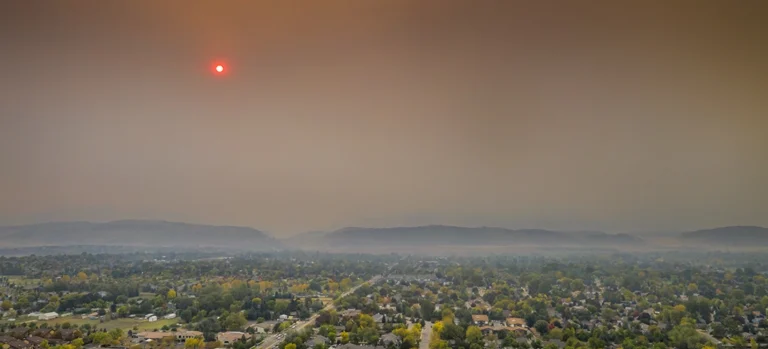 Wide view of a smoky sky near a wildfire.